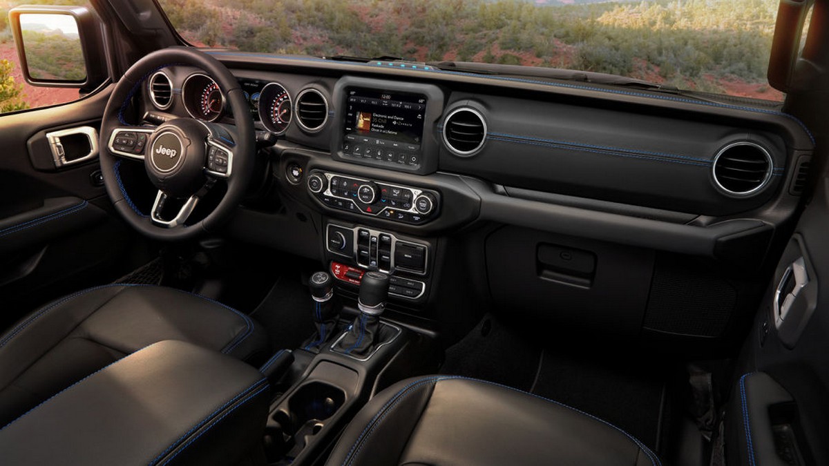 Interior of the 2021 Jeep® Wrangler Rubicon 4xe includes Surf Blue accent stitching on seats and interior trim.